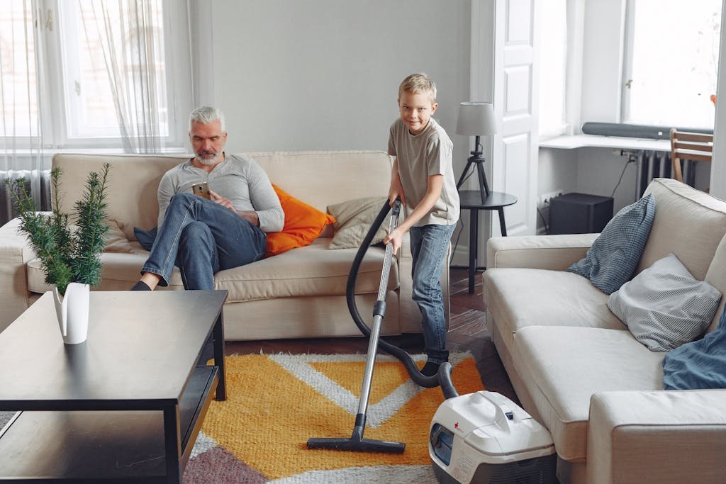 Man In Blue Denim Jeans Sitting On Couch