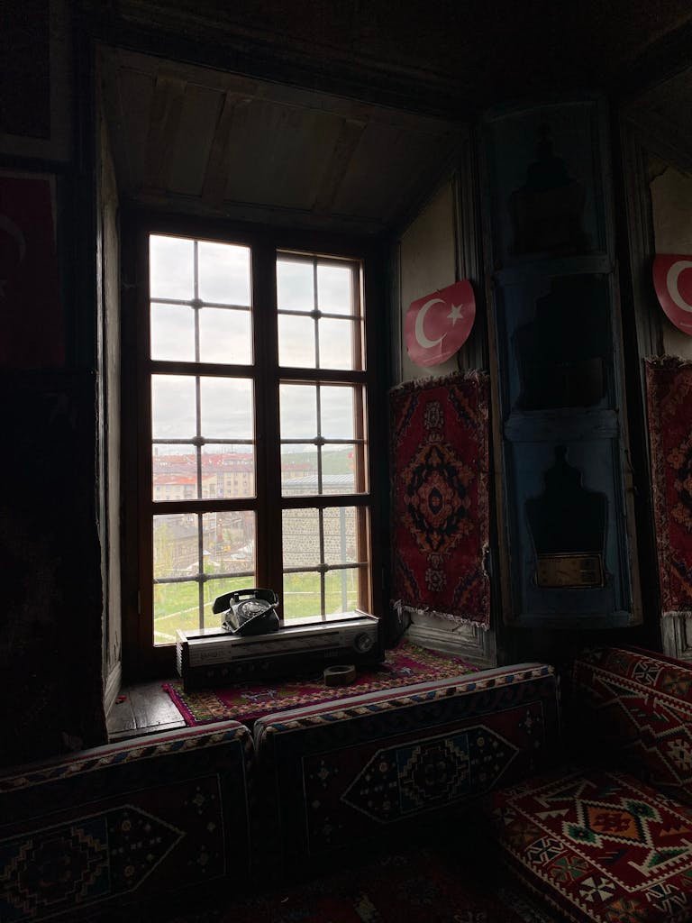 A window in a room with a rug and a rug