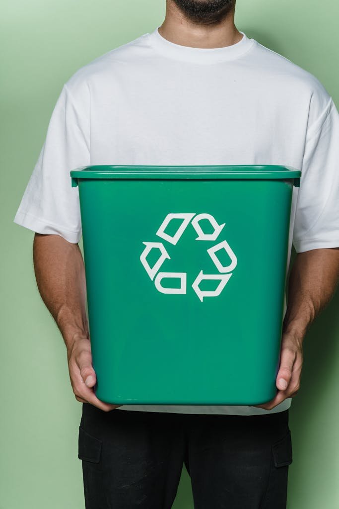 Man in White T-shirt Holding Green Box