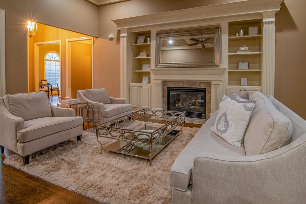 A Photo of a living room with rugs on floor and sofa