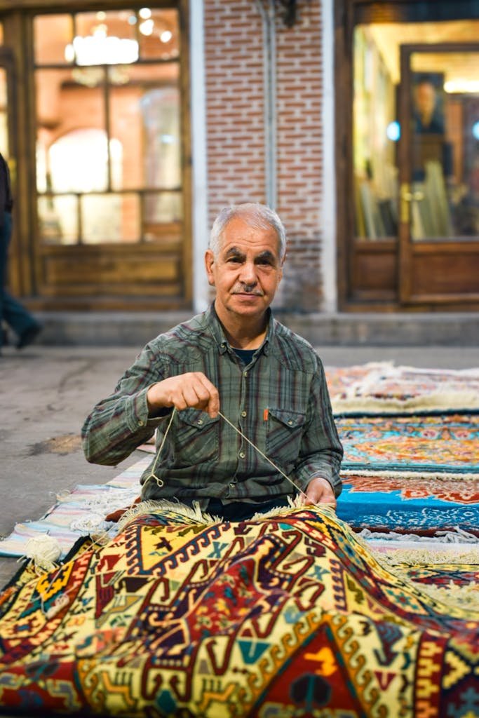 a man is making woven rug