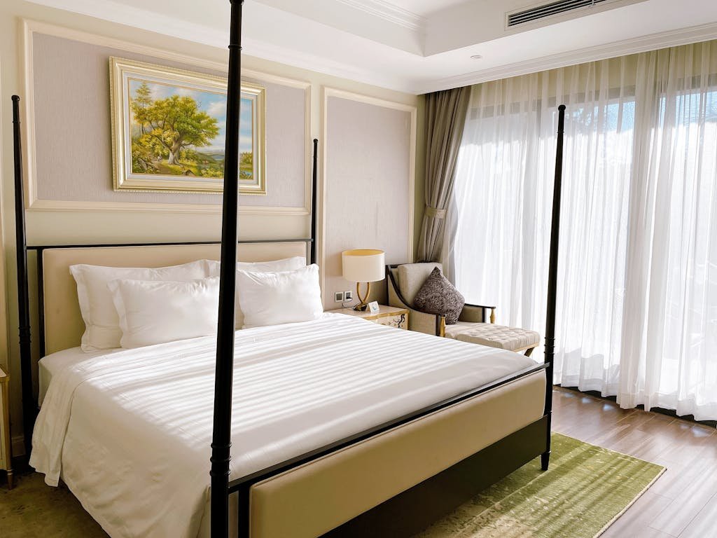 The Interior of a Bedroom in a House where a bed is lay on the area rug