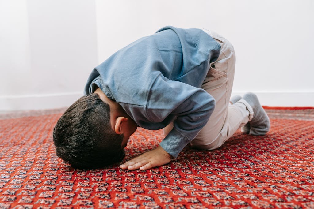 A Boy Kneeling on the rug