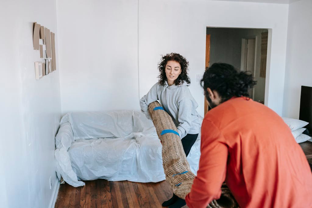 Couple Carrying A Rolled sheepskin Carpet