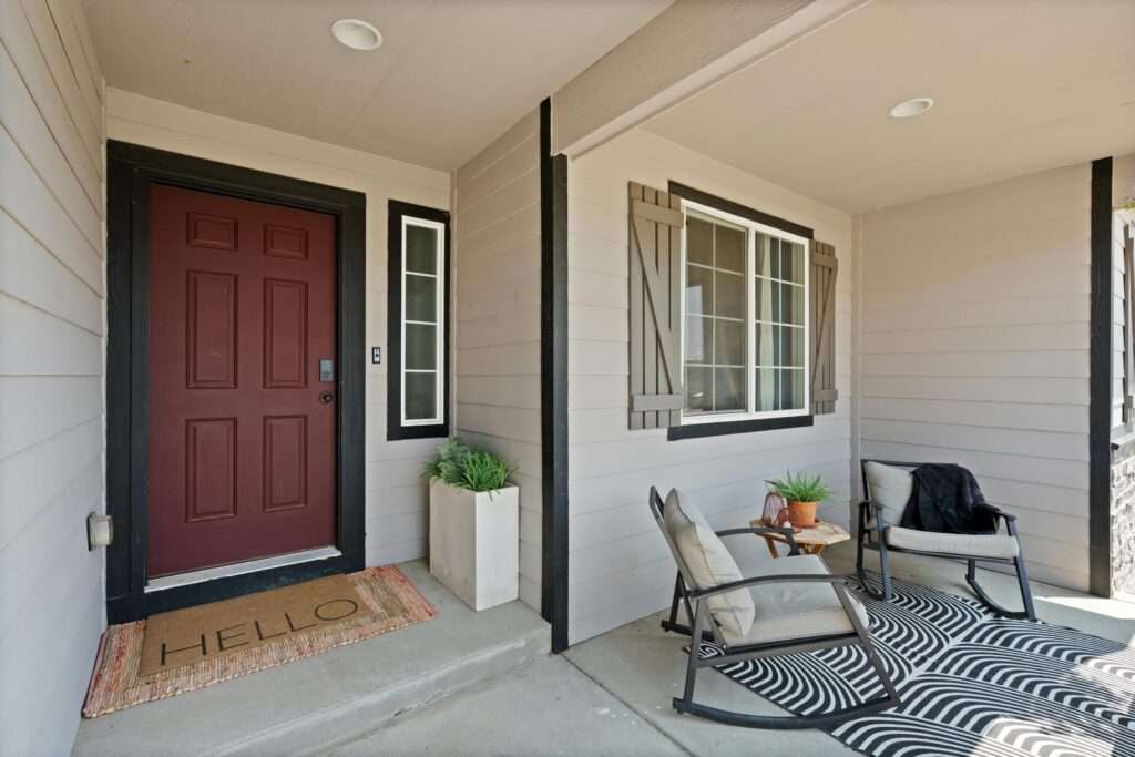 A beautiful entryway with chairs, runner rug and other decors