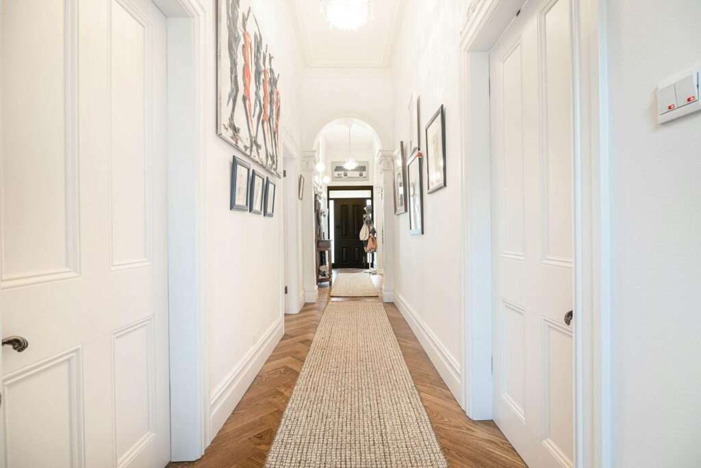 a long beautiful hallway with runner rug